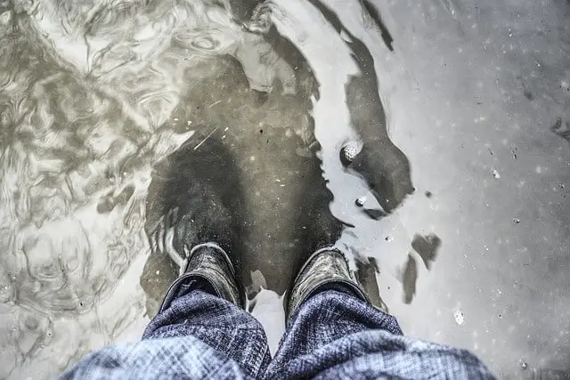 Standing in water with rubber boots on