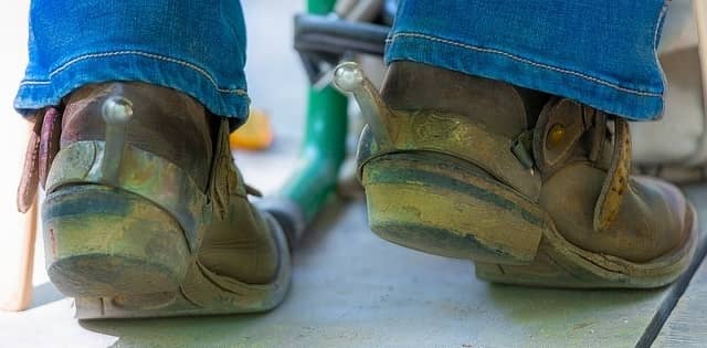 Standing while wearing cowboy boots