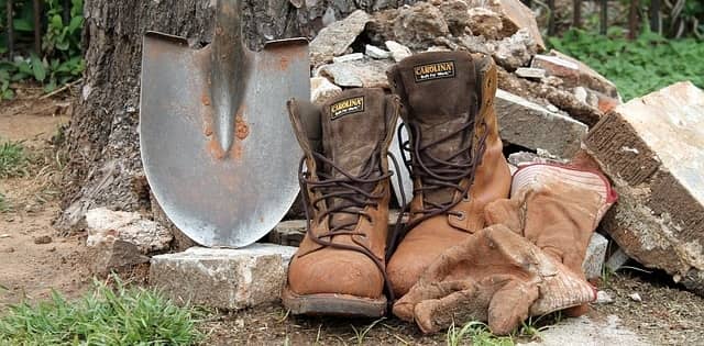 brown work boots with a shovel