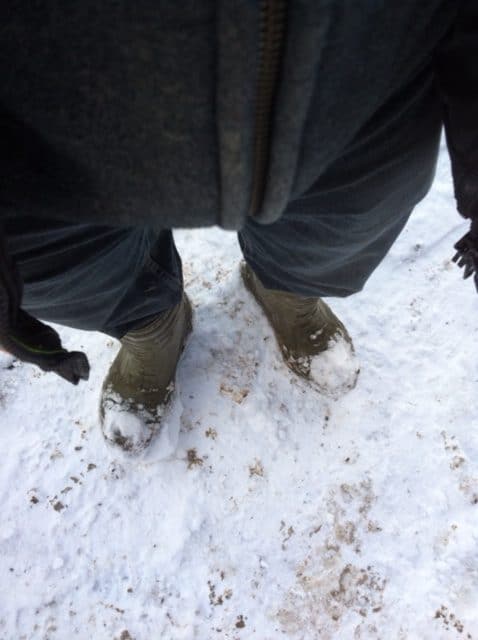 Person standing wearing cofra rubber boots in snow