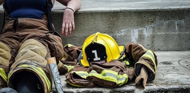 Woman Fire Fighter sitting on a concrete step